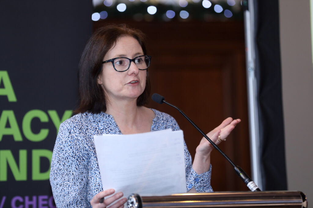 Photo of Dr Cara Greene, Education and Public Engagement Projects Lead at ADAPT, at podium.