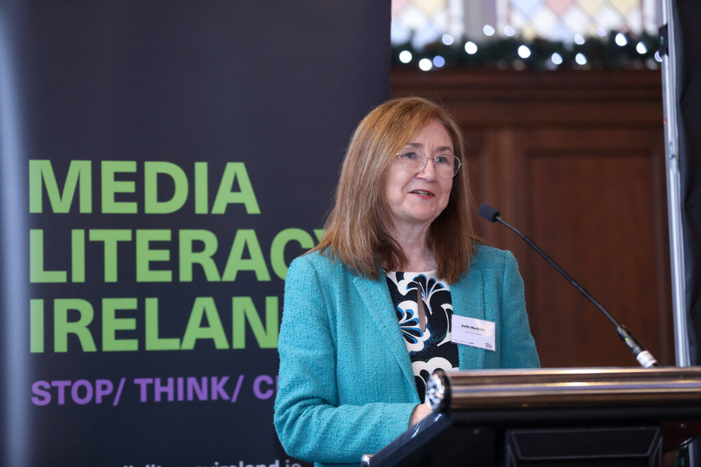 Photo of Aoife MacEvilly, Coimisiún na Meán’s Commissioner for Broadcasting and Video on Demand, at podium.